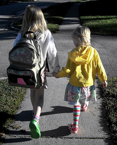 Two Young Girls Walking to School