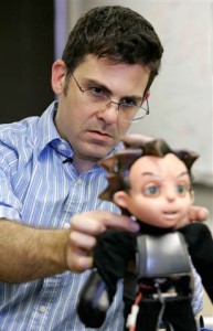 Creator David Hanson is shown making an adjustment to the robot prior to an interview.