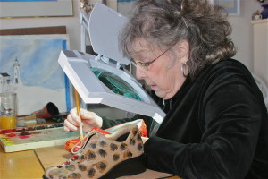 barbara painting corrective shoe under magnifier