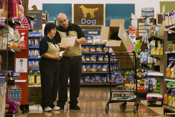 employee working at pet store pre-ets