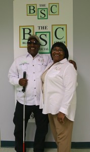 Mr. and Mrs. Blair in front of TBSC sign