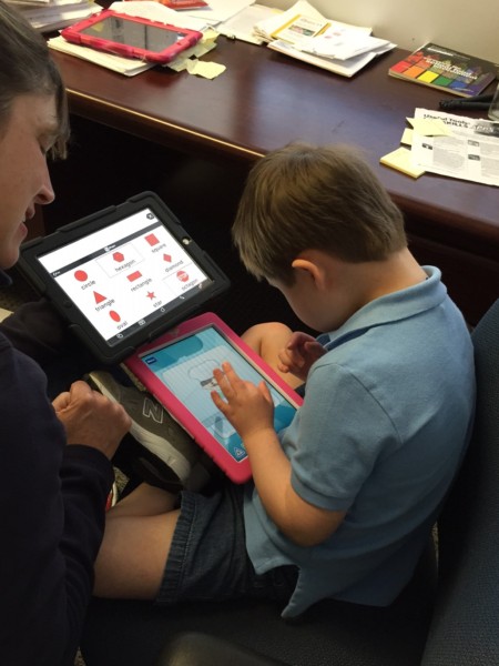 Boy on tablet with teacher