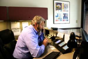 Gary Bradley at reception desk at Rose Acre Farms