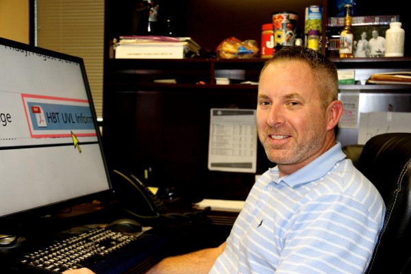 greg sitting at his desk