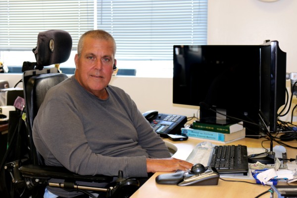 Thomas sitting at his desk 