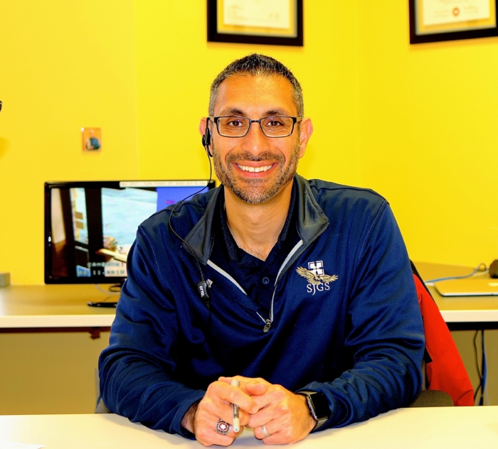 George Azar sitting at his desk