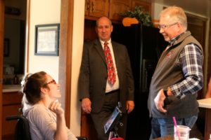 craig, ashley's dad, and ashley talking in the kitchen