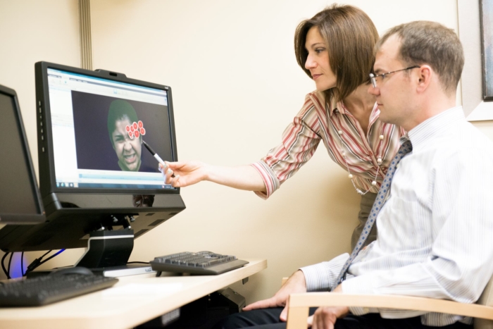 Patient working with therapist on computer
