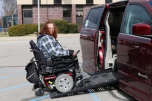 Roxanne entering her van on wheelchair ramp 