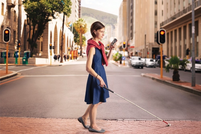 Person crossing the street with Victor Reader Trek