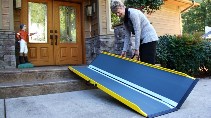 Woman folding up suitcase ramp