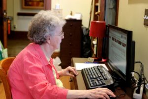 Sister Gloria using desktop computer