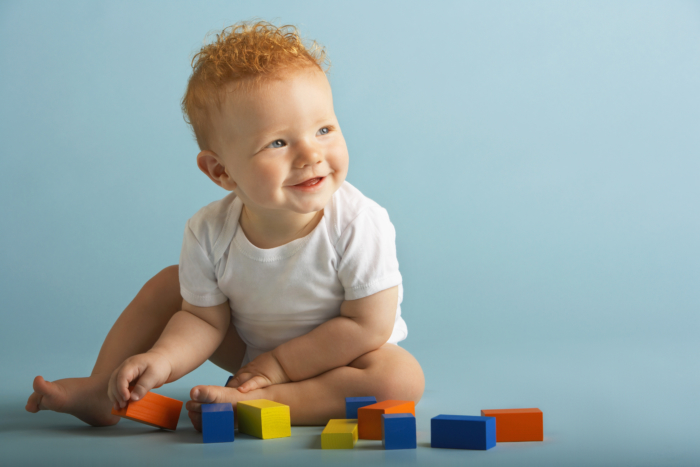 Redheaded Baby Playing With Blocks