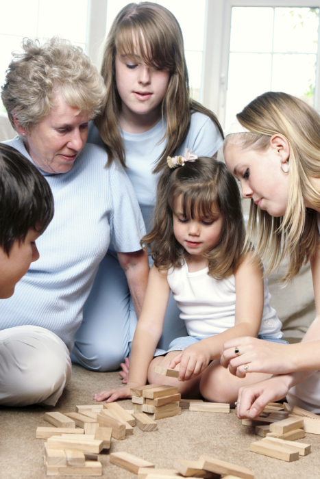 Grandmother and kids with building blocks