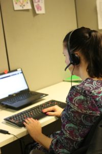 Kristy working at her desk