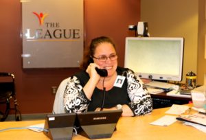 Anne Palmer answering phones at The League