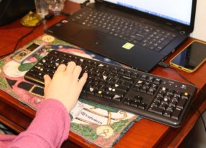 Labels on Billie's keyboard to help her identify keys