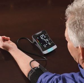 Man with blood pressure monitor cuff on his arm