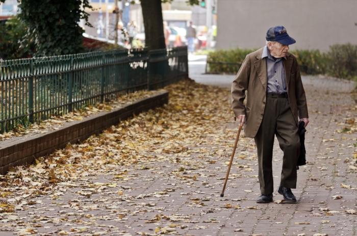 Veteran walking with cane