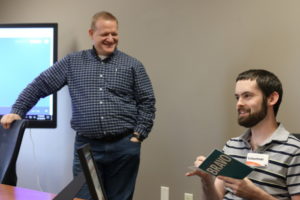 Kevin Kopf receiving a card from staff