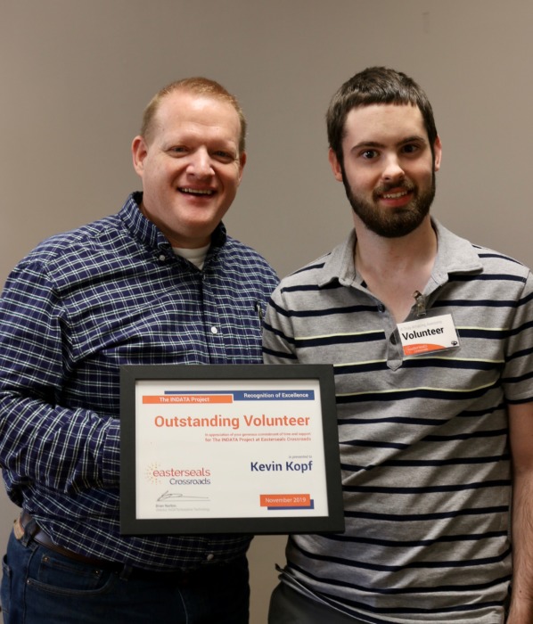 Brian Norton awarding Kevin with Outstanding Volunteer certificate