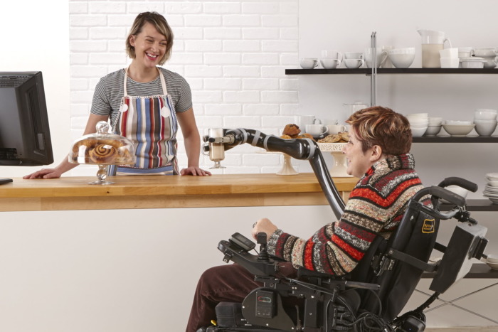 Person in wheelchair with JACO arm