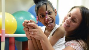 Erionna, a 6-year-old girl who works with our physical therapists and is making progress on sitting, holding her head up, standing and becoming mobile with her gait trainer.