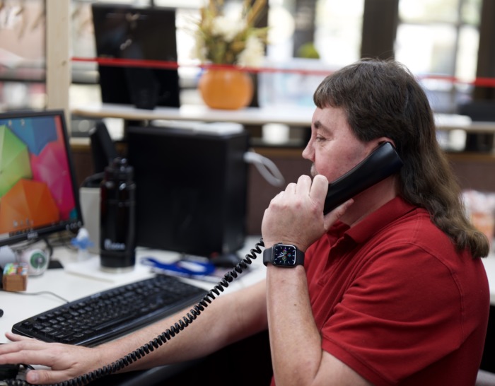 Randy Berg answering phone at his desk