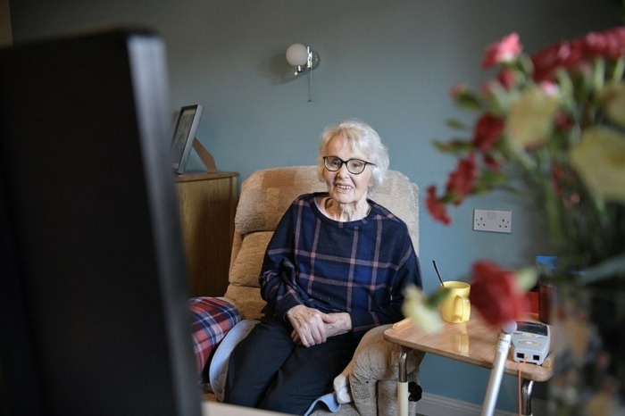 Older woman looking at TV monitor