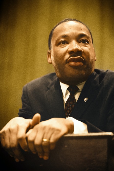 Photo of MLK Jr. at a podium giving a speech 