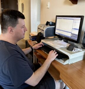Justin Jones working at his computer using JAWS screen reader