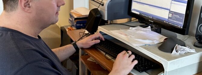 Justin Jones working at his computer using JAWS screen reader