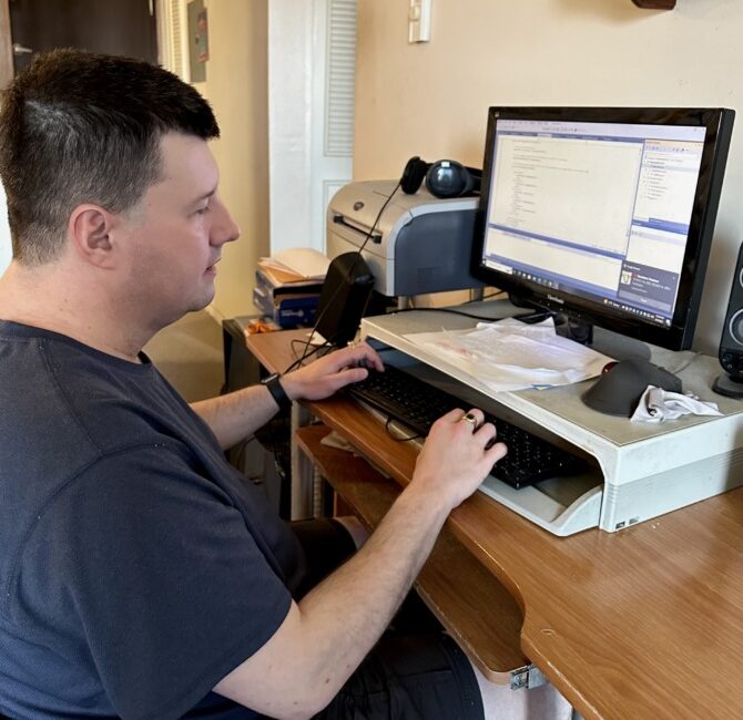 Justin Jones working at his computer using JAWS screen reader