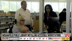 screenshot of Brian Norton showing WISH TV reporter and Laura Medcalf the accessible workstation at the library