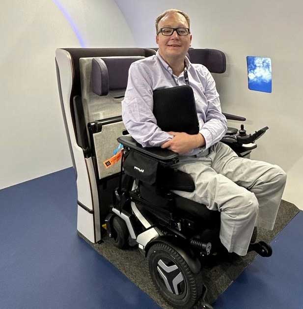 Man sitting in wheelchair using Air4All system in demo