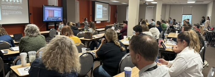 photo of a group of people at a full day training in classroom style seating