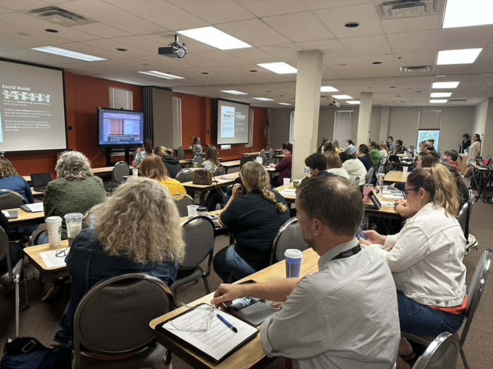 photo of a group of people at a full day training in classroom style seating